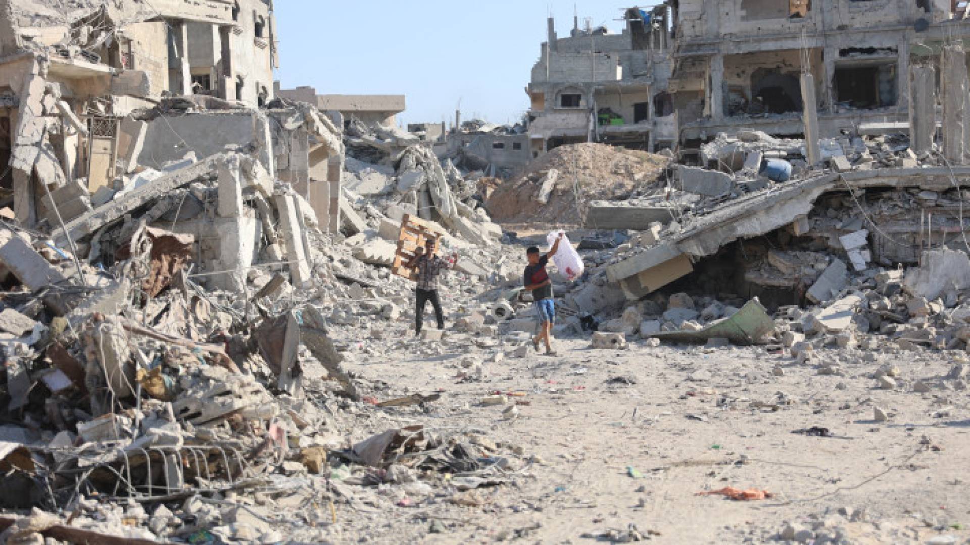 فلسطينيون وسط أنقاض المباني المدمرة بعد انسحاب جيش الاحتلال من حي الشجاعية