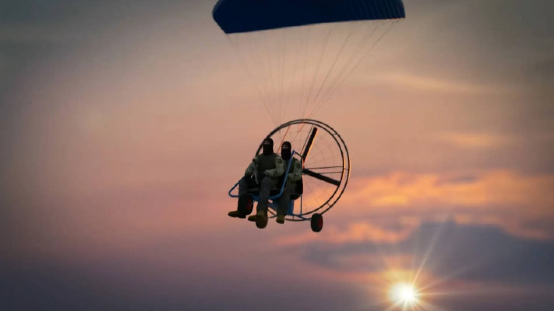 عنصران من المقاومة الفلسطينية يستخدمان طائرة شراعية