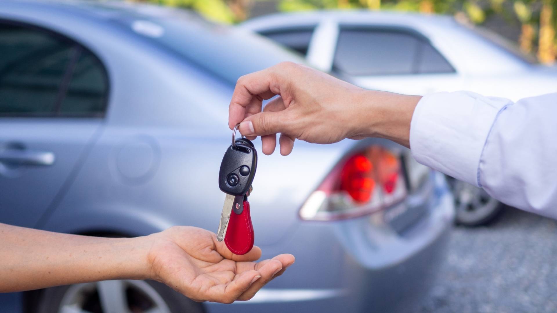 شخص يعطي مفتاح سيارة لآخر