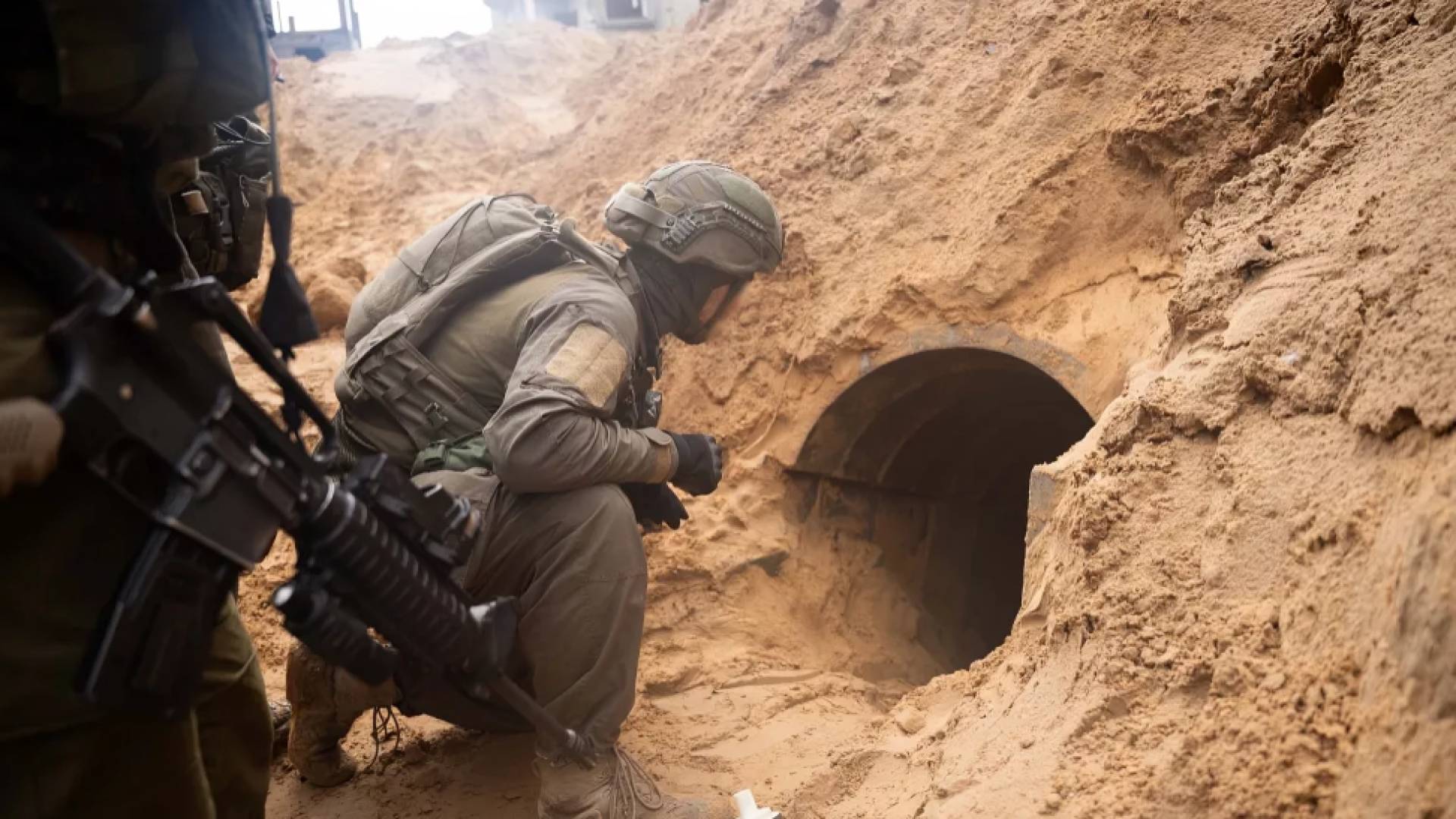 جندي من جيش الاحتلال ينظر إلى فتحة نفق في قطاع غزة