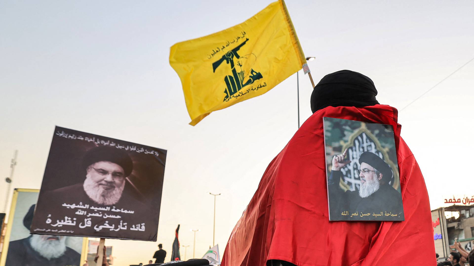 شخص يعلق على ظهره صورة حسن نصالله