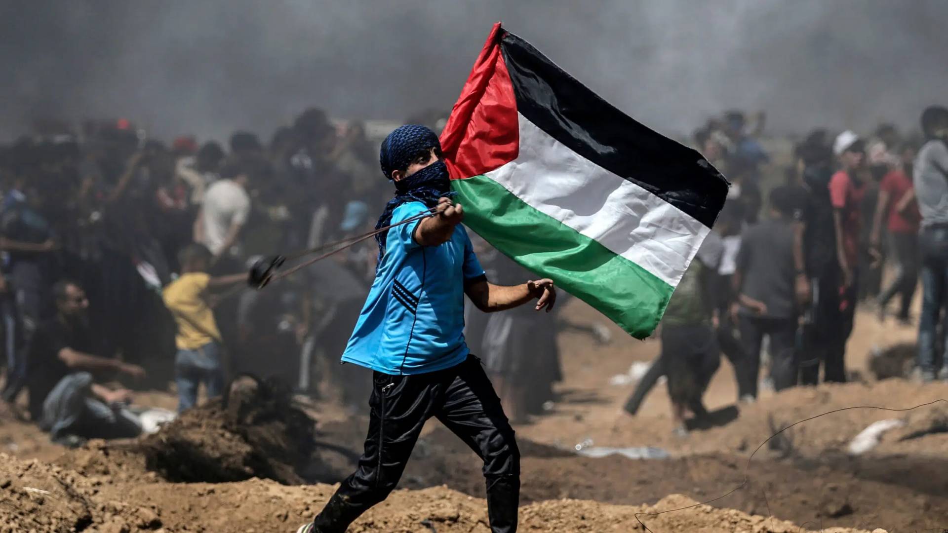 فلسطيني يرفع علم فلسطين ويواجه جيش الاحتلال