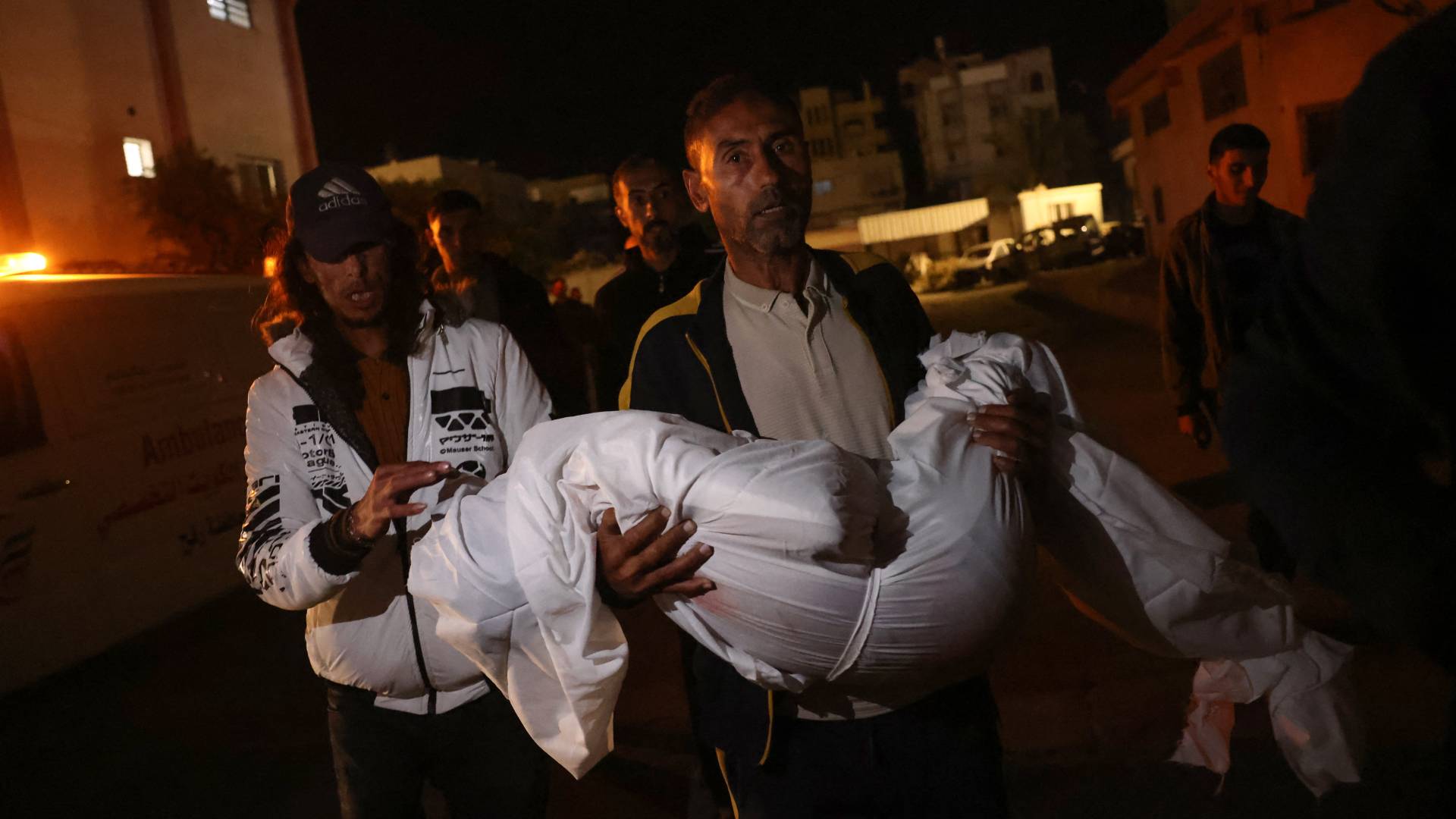 فلسطيني يحمل جثمان أحد أفراد عائلته في غزة