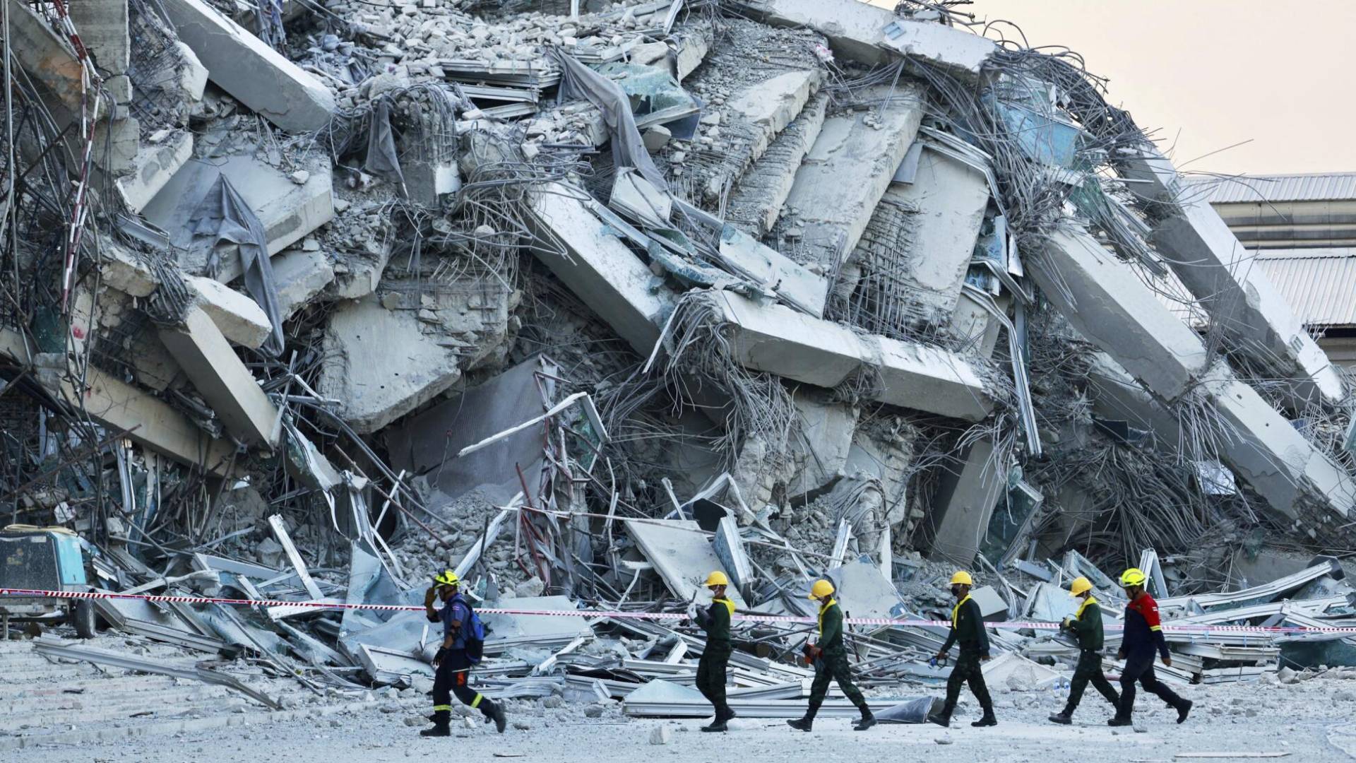 يعمل رجال الانقاذ في موقع بناء شاهق انهار في بانكوك