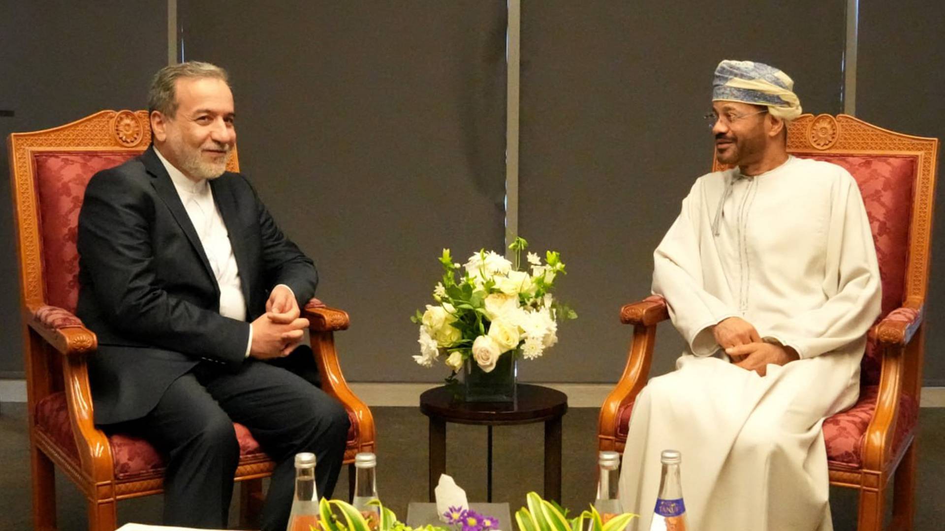 وزير الخارجية الإيراني عباس عراقجي (يسار) خلال لقائه مع وزير الخارجية العماني بدر البوسعيدي (يمين) في مسقط