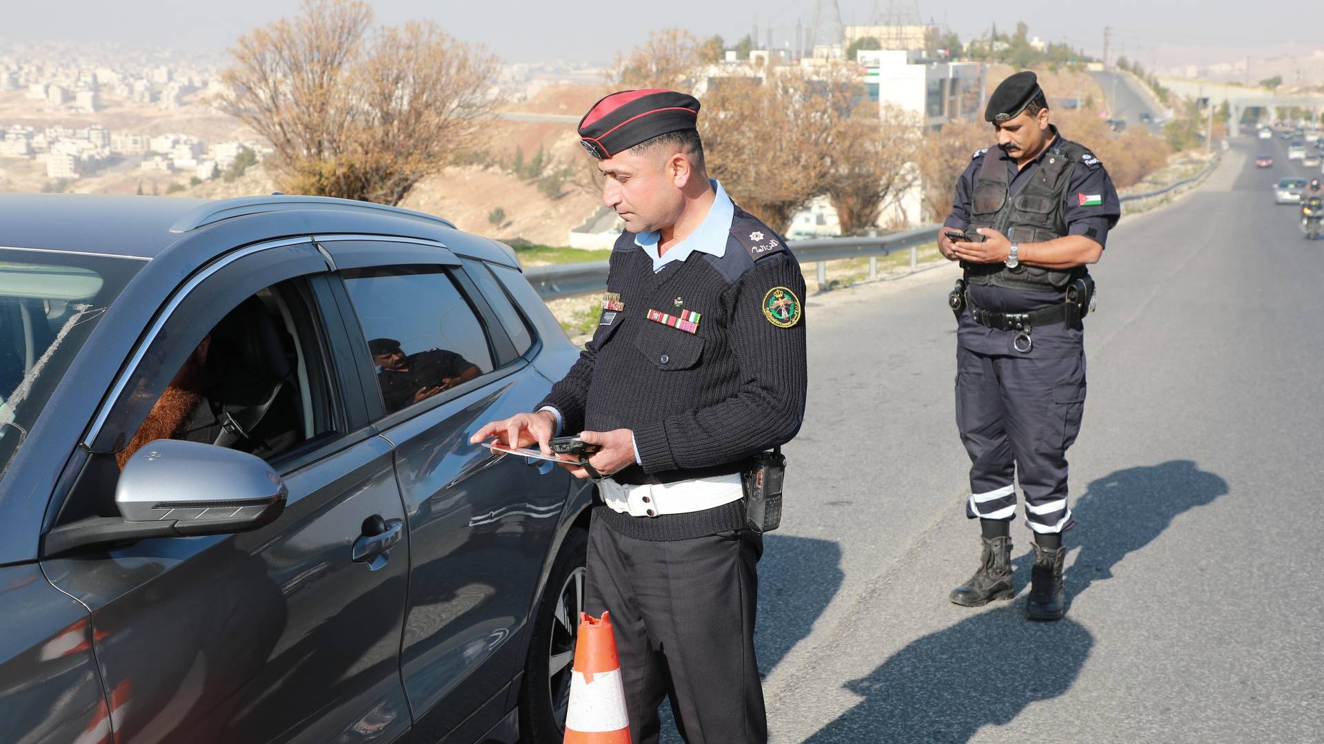 احد كوادر الأمن العام يجري تشخصيا على إحدى المركبات