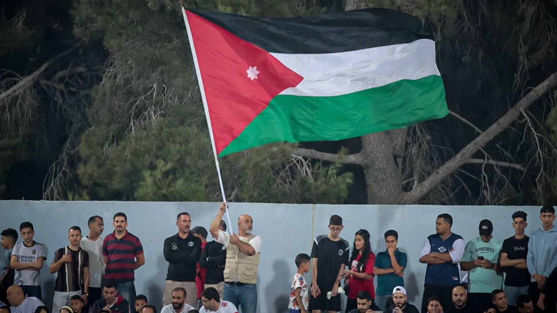 مشجع يرفع العلم الأردني في ستاد عمان الدولي