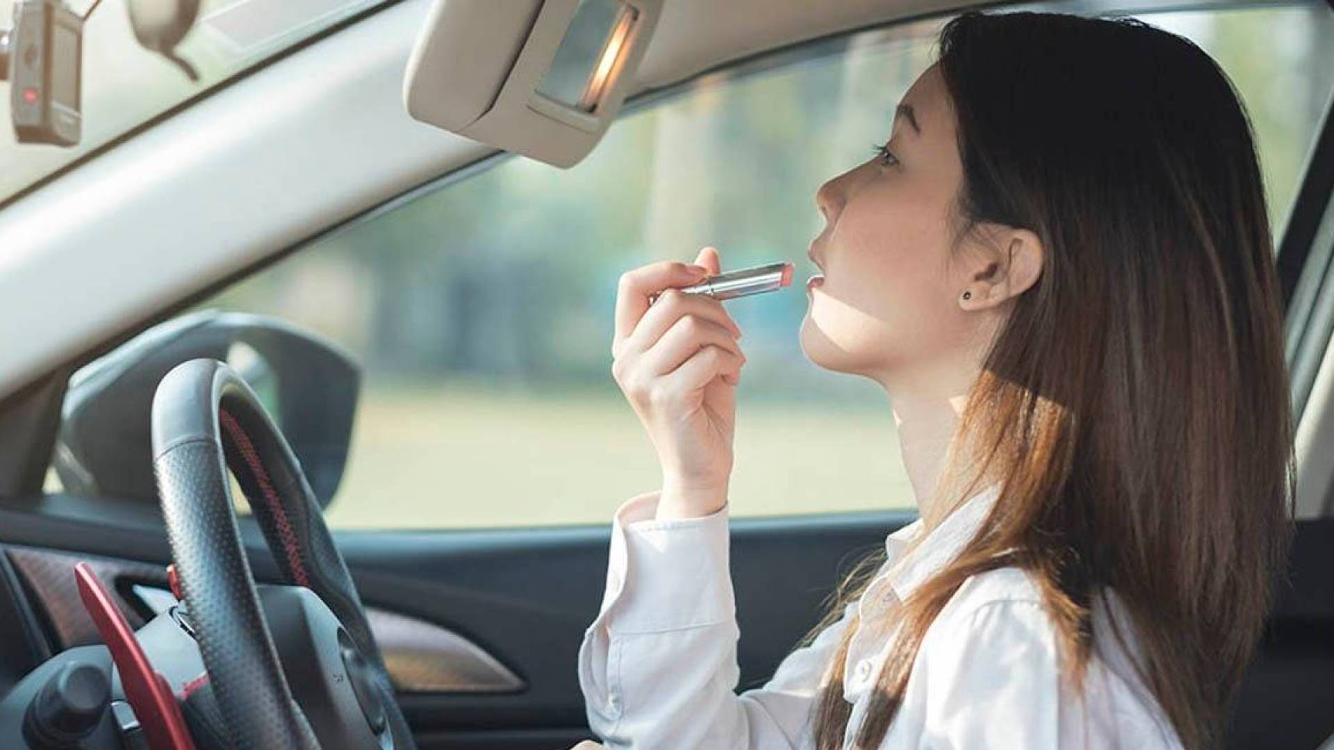 سيدة تضع مكياج في السيارة