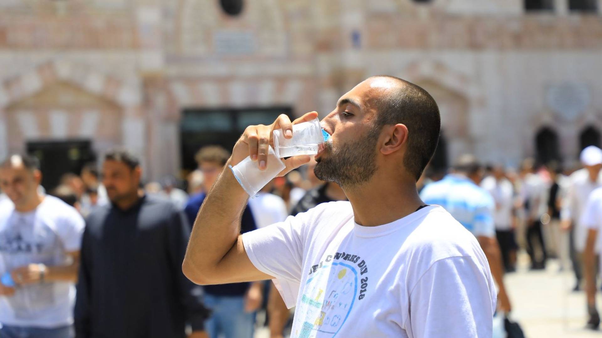 مواطن يشرب الماء في حرارة الصيف