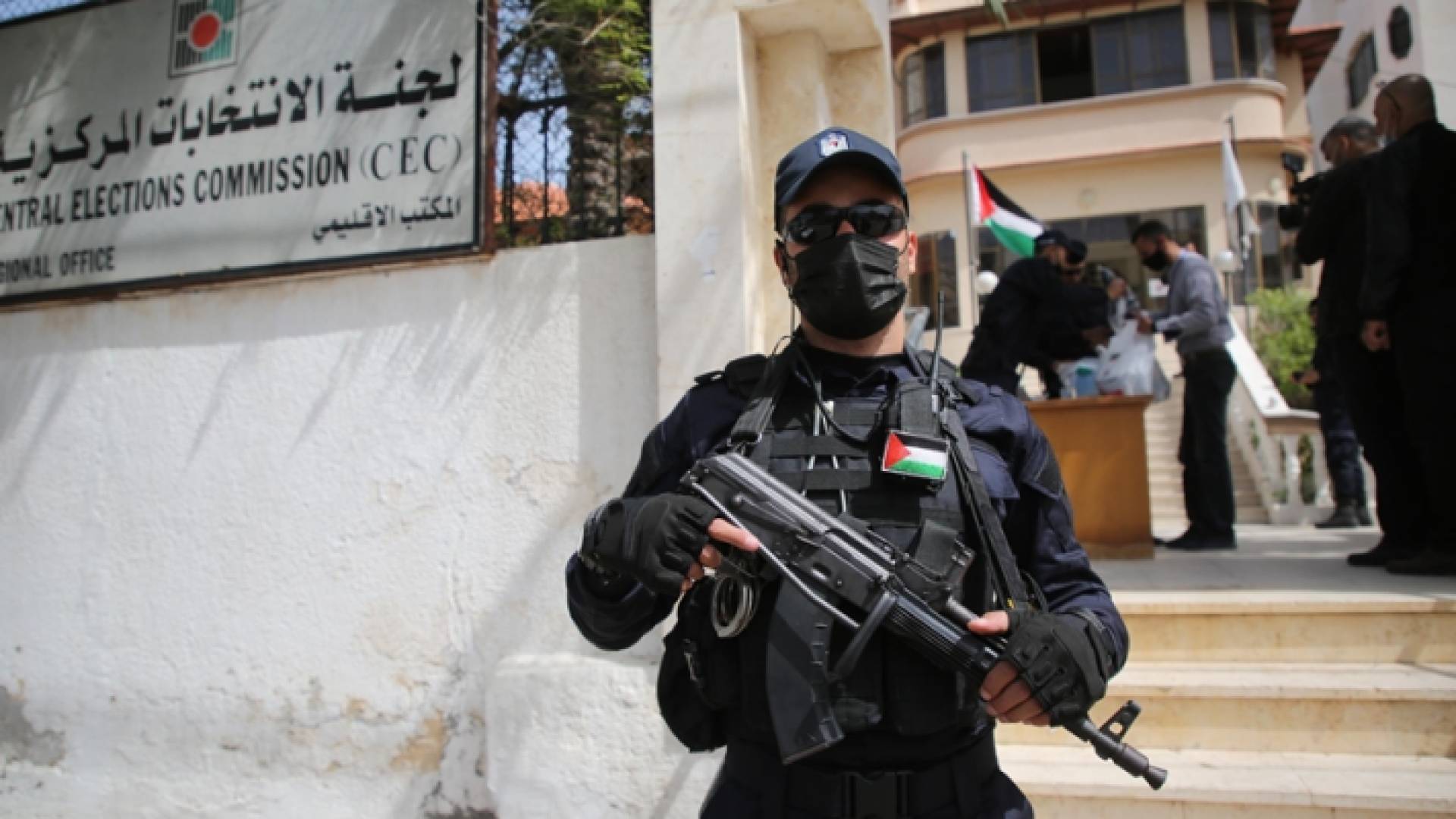 عنصر أمني يقف أمام مبنى لجنة الانتخابات المركزية الفلسطينية