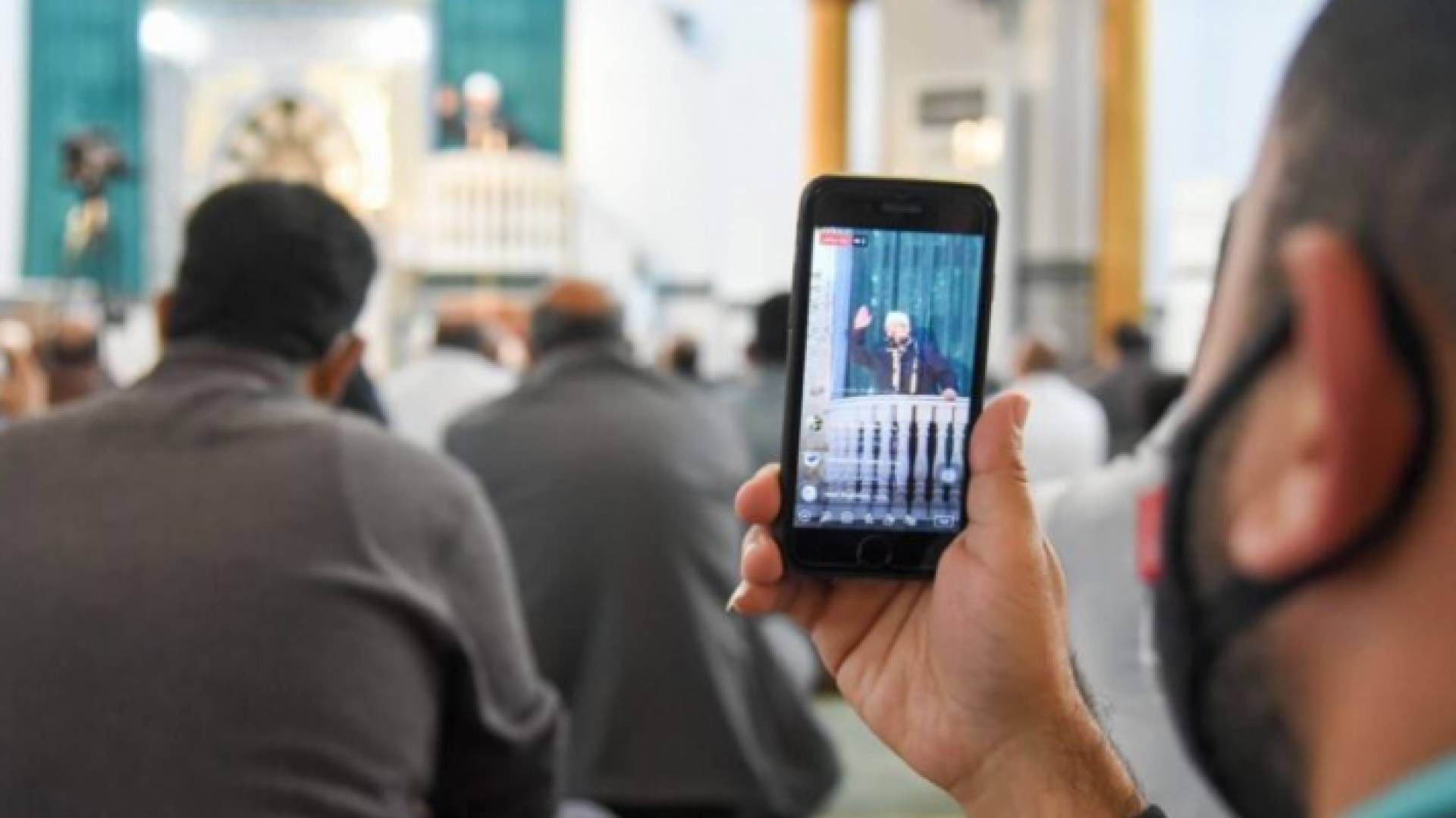 مصل يستخدم هاتفه في المسجد - تعبيرية