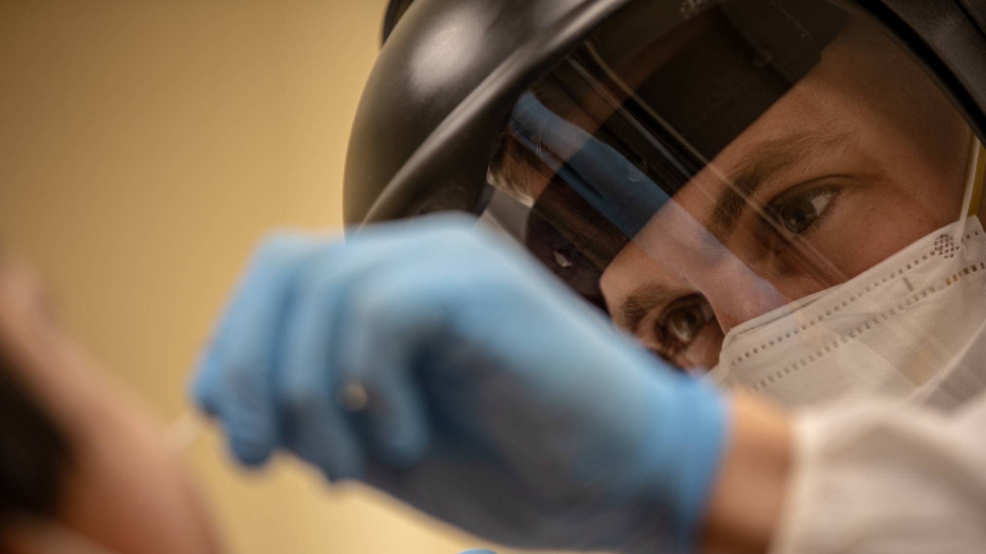 أحد كوادر وزارة الصحة الفلسطينية يأخذ مسحة من شاب للتحقق من إصابته بكورونا - ارشيفية