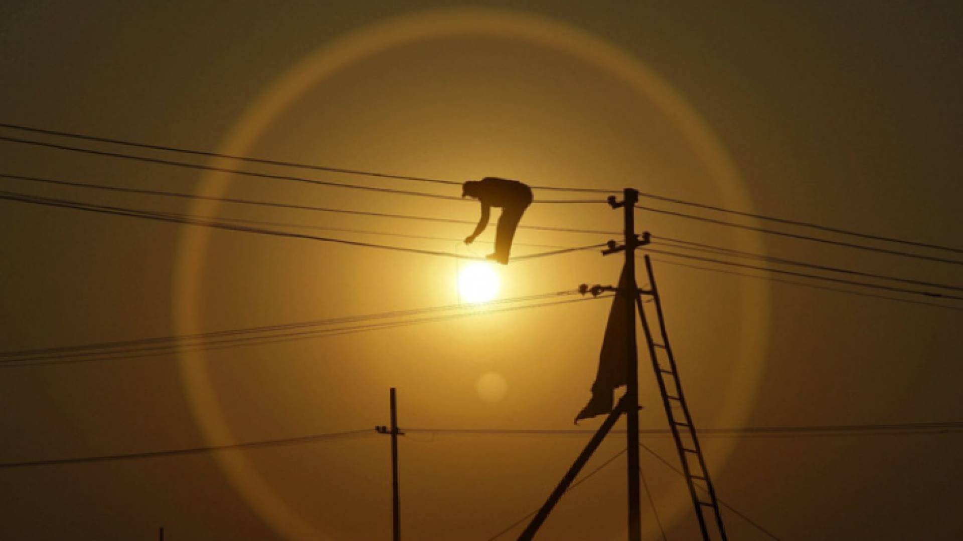 عامل يجري صيانة لخطوط كهرباء - أرشيفية