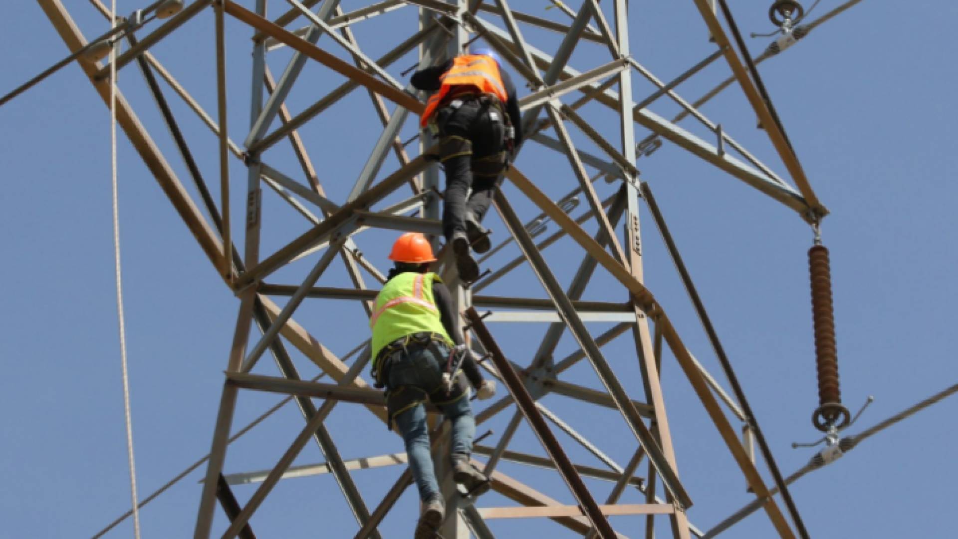 عمال في شركة الكهرباء يجرون أعمال صيانة - أرشيفية