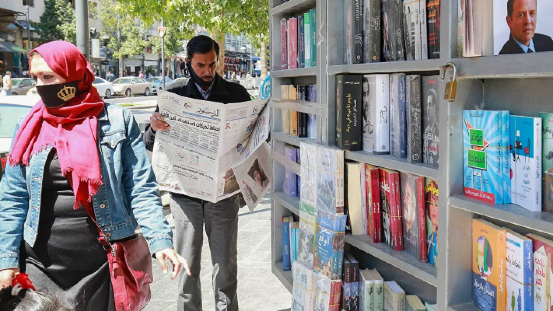 رجل يقرأ صحيفة على جانب الطريق في عمان