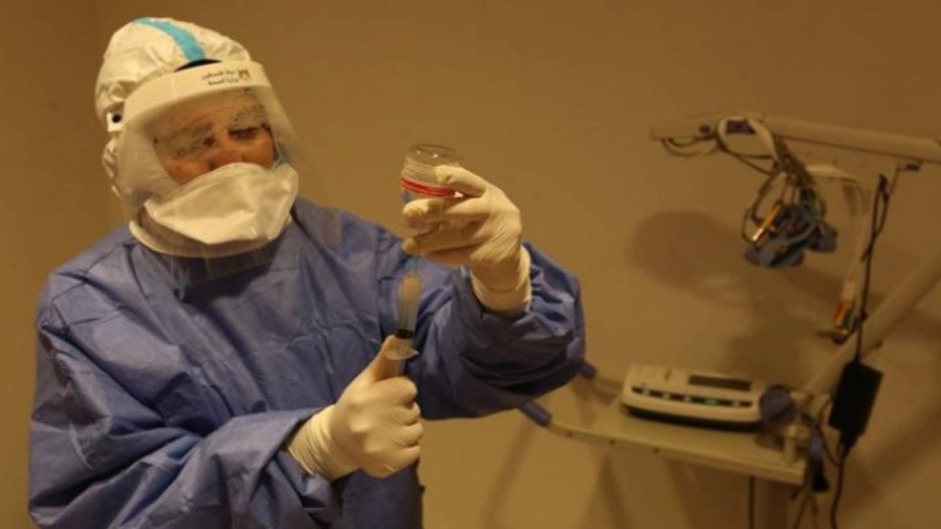 عامل في القطاع الصحي الفلسطيني يحضّر جرعة من لقاح كورونا - أرشيفية