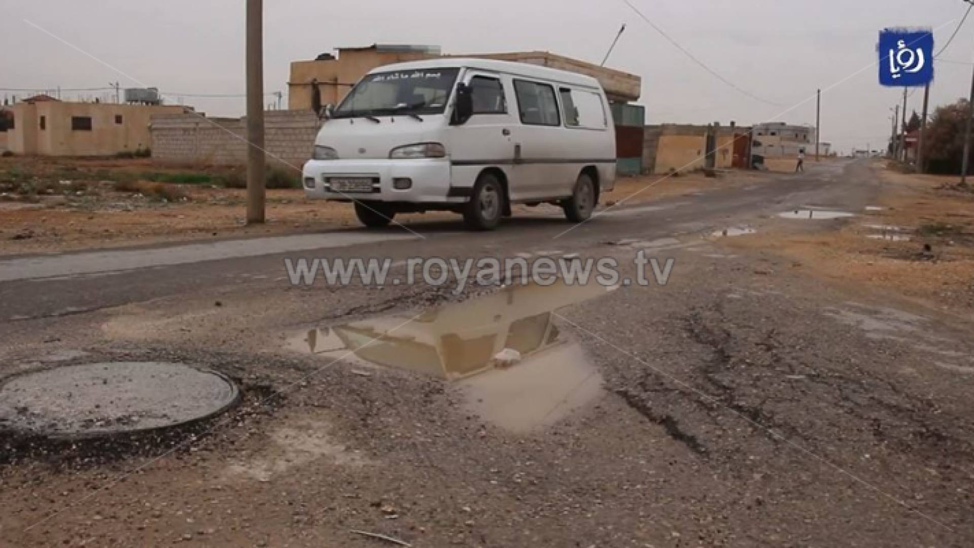 حافلة صغيرة تسير على طريق متهالك