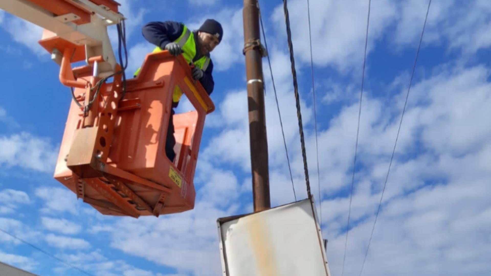 عامل في وزارة الأشغال يزيل لوحة إعلانية مخالفة