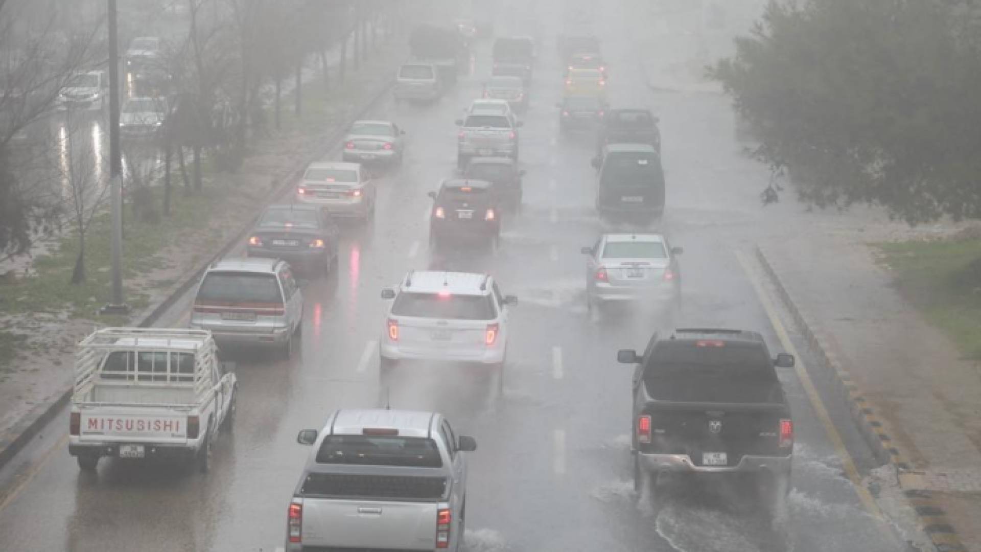 مركبات في أحد شوارع العاصمة عمان أثناء هطول الأمطار