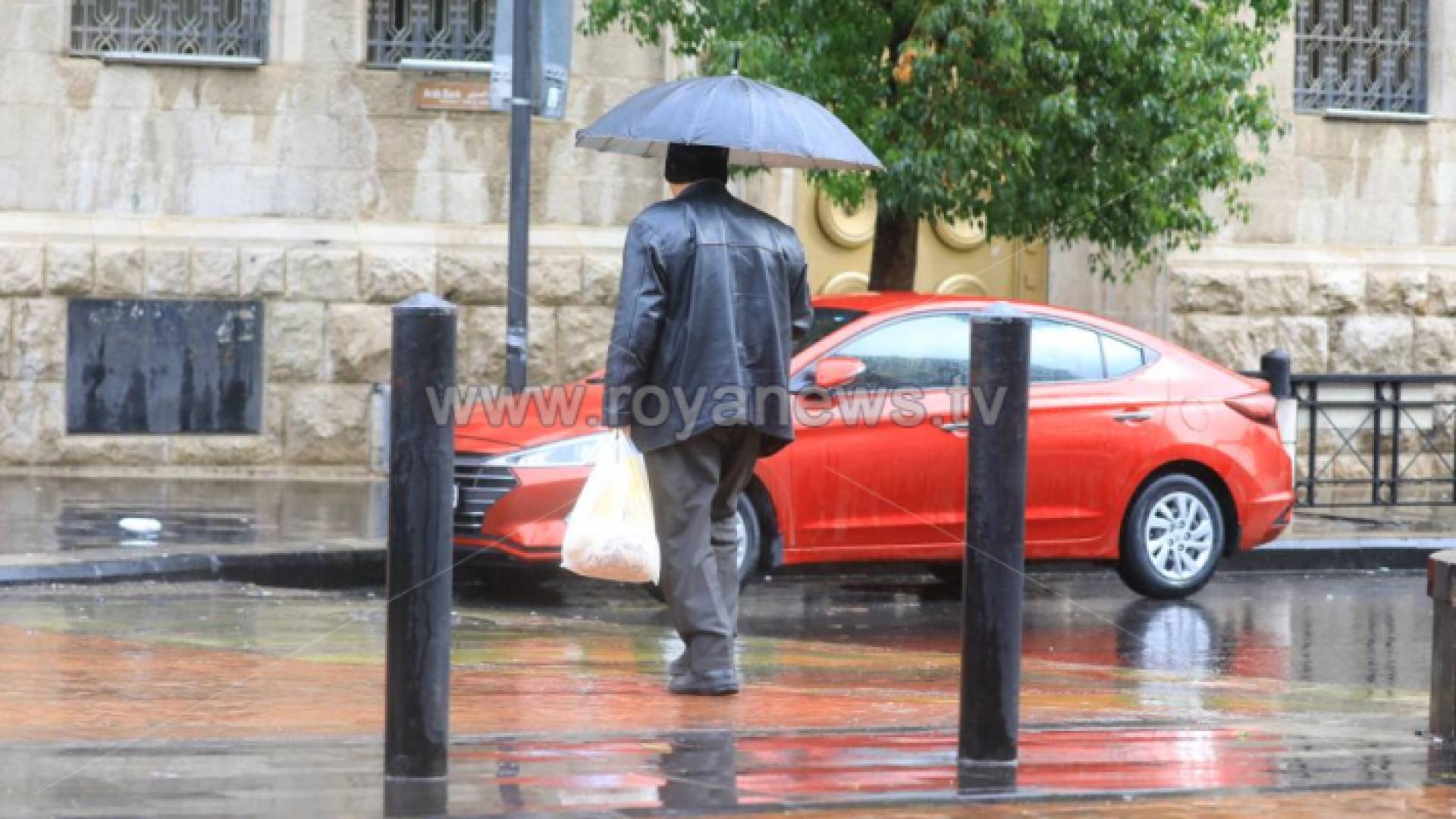 رجل يسير في أجواء ماطرة