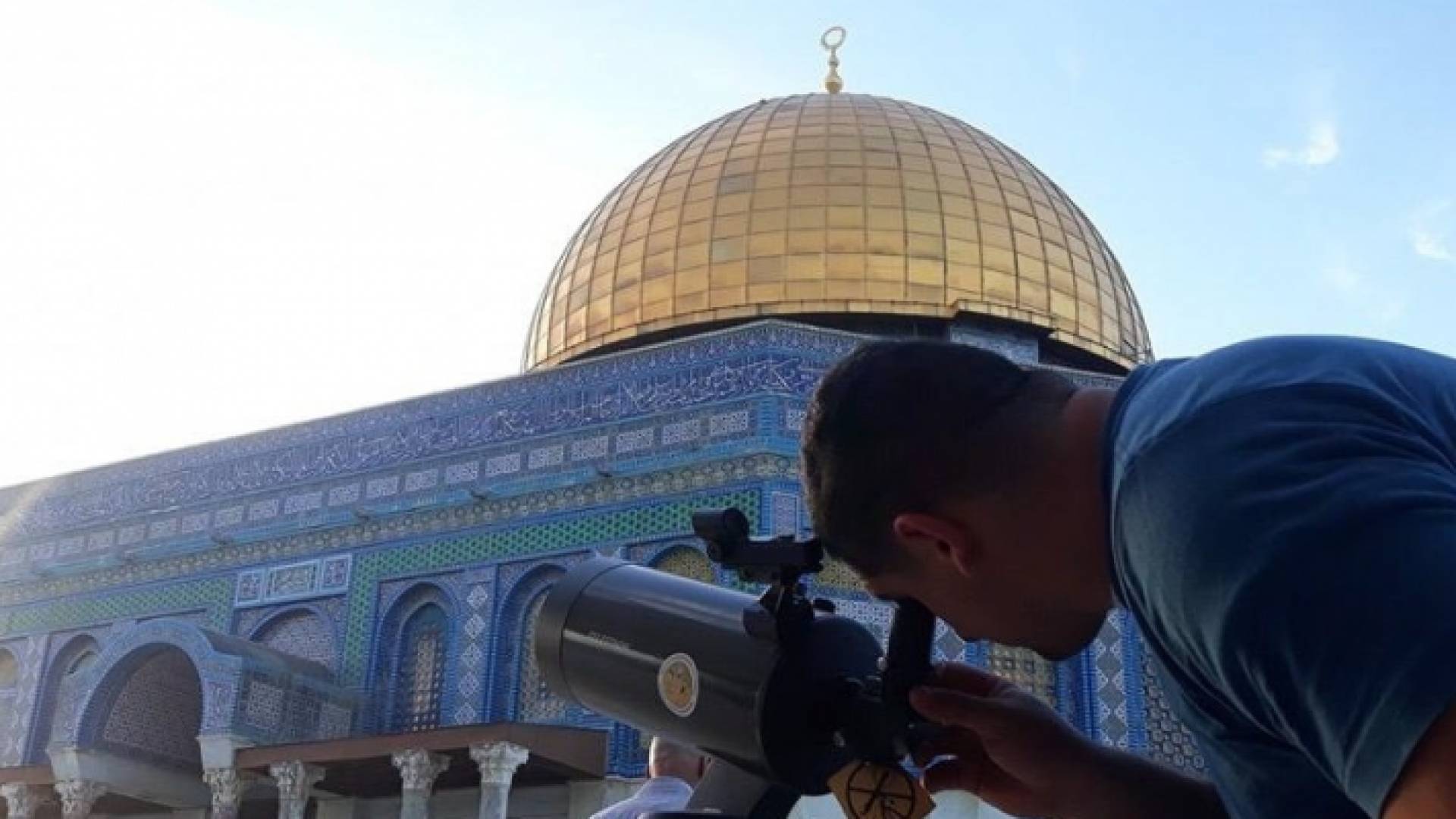 شخص ينظر في تلسكوب بالقرب من قبة الصخرة