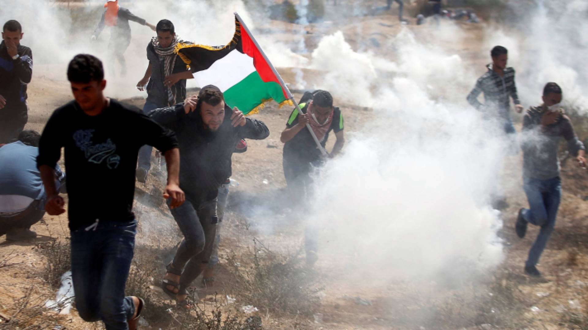 فلسطينيون يحاولون الهرب من الغاز السام الذي يطلقه الاحتلال