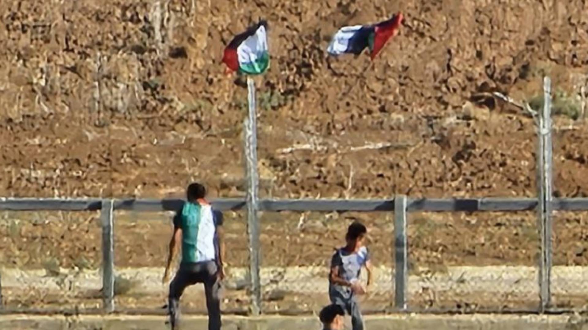 شبان فلسطينيون بالقرب من السياج الحدود