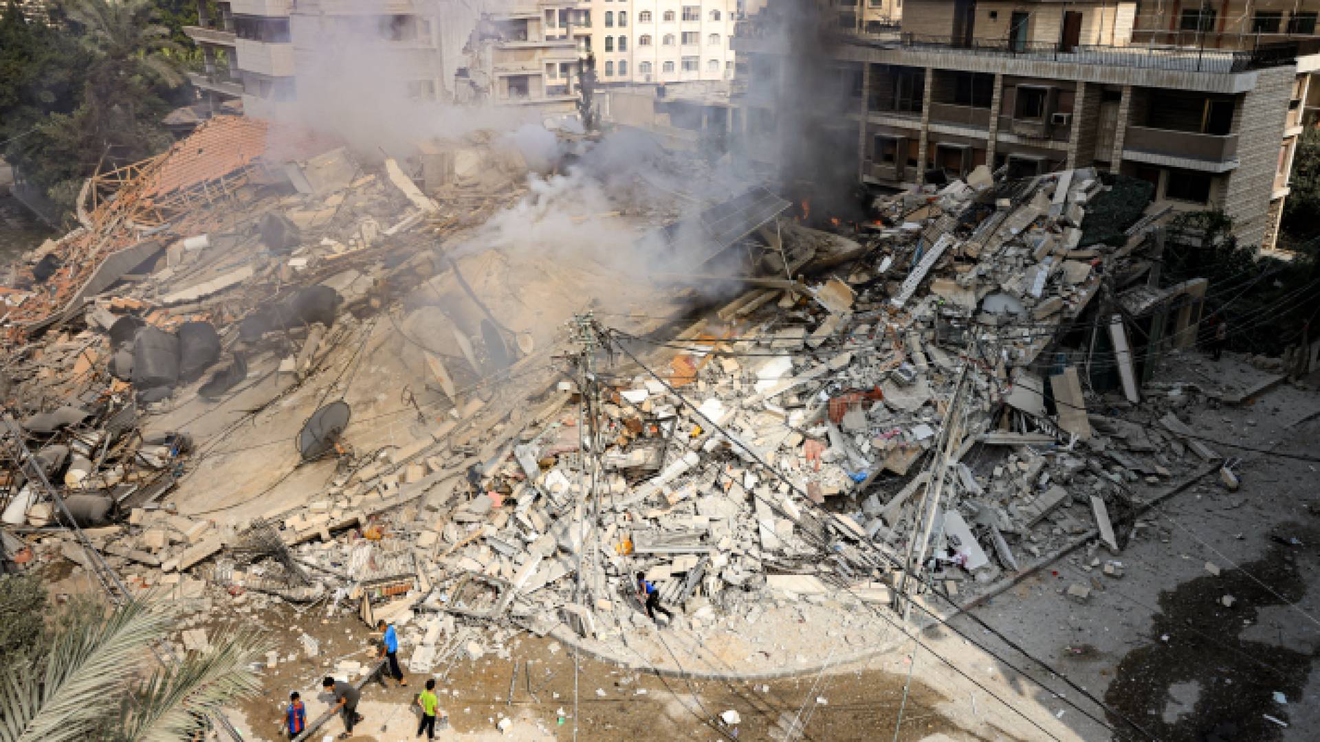 تتصاعد الدخان من أنقاض مبنى تدمر جراء ضربة جوية إسرائيلية في قطاع غزة