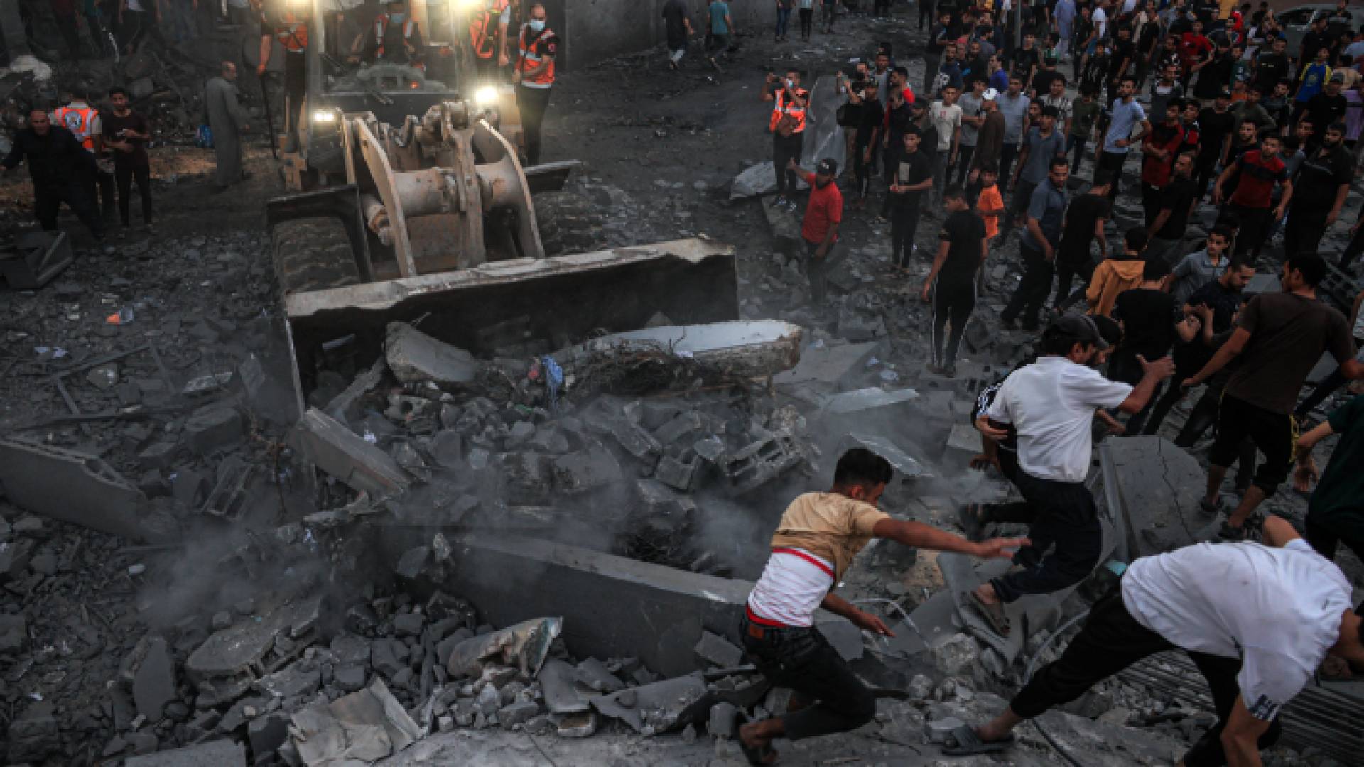 فلسطينيون فوق أنقاض عمارة سكنية تم تدميرها في غزة