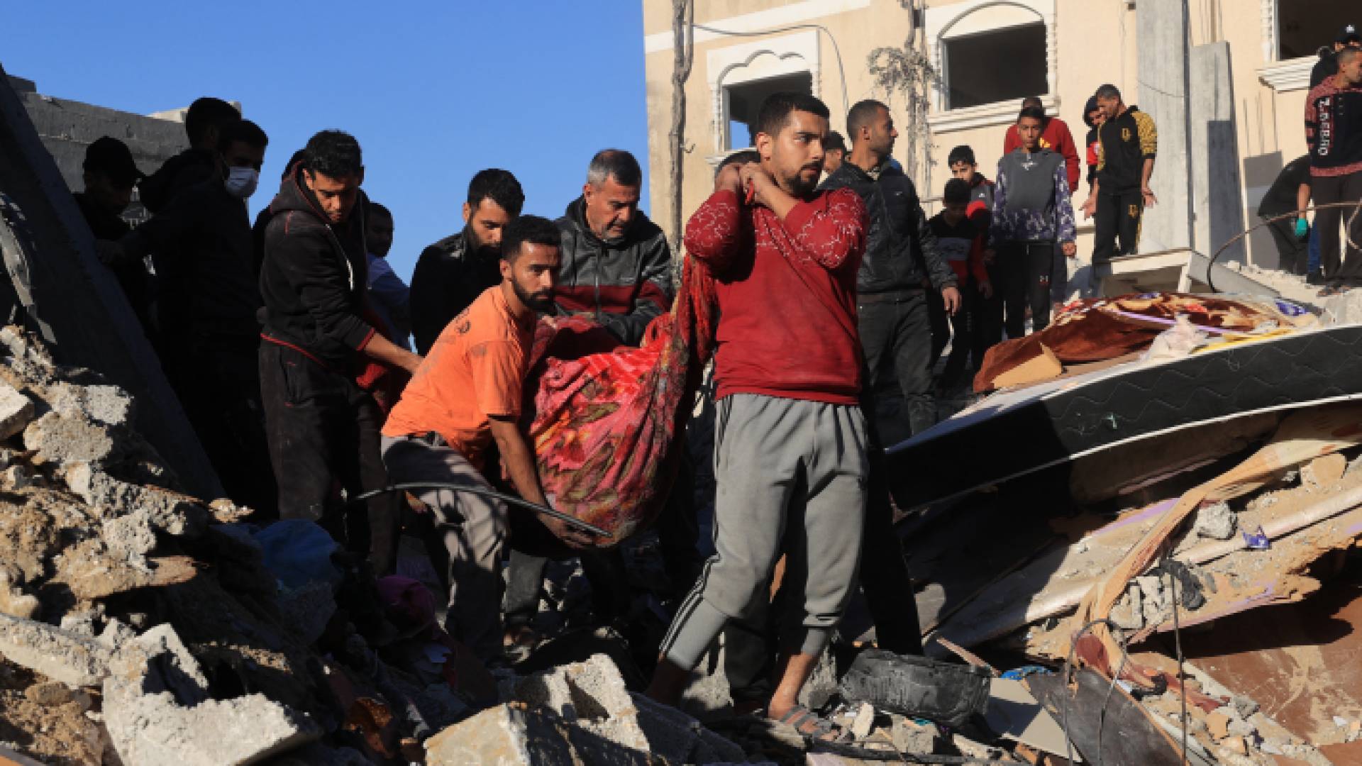 فلسطينيون ينتشلون أحد الشهداء في غزة