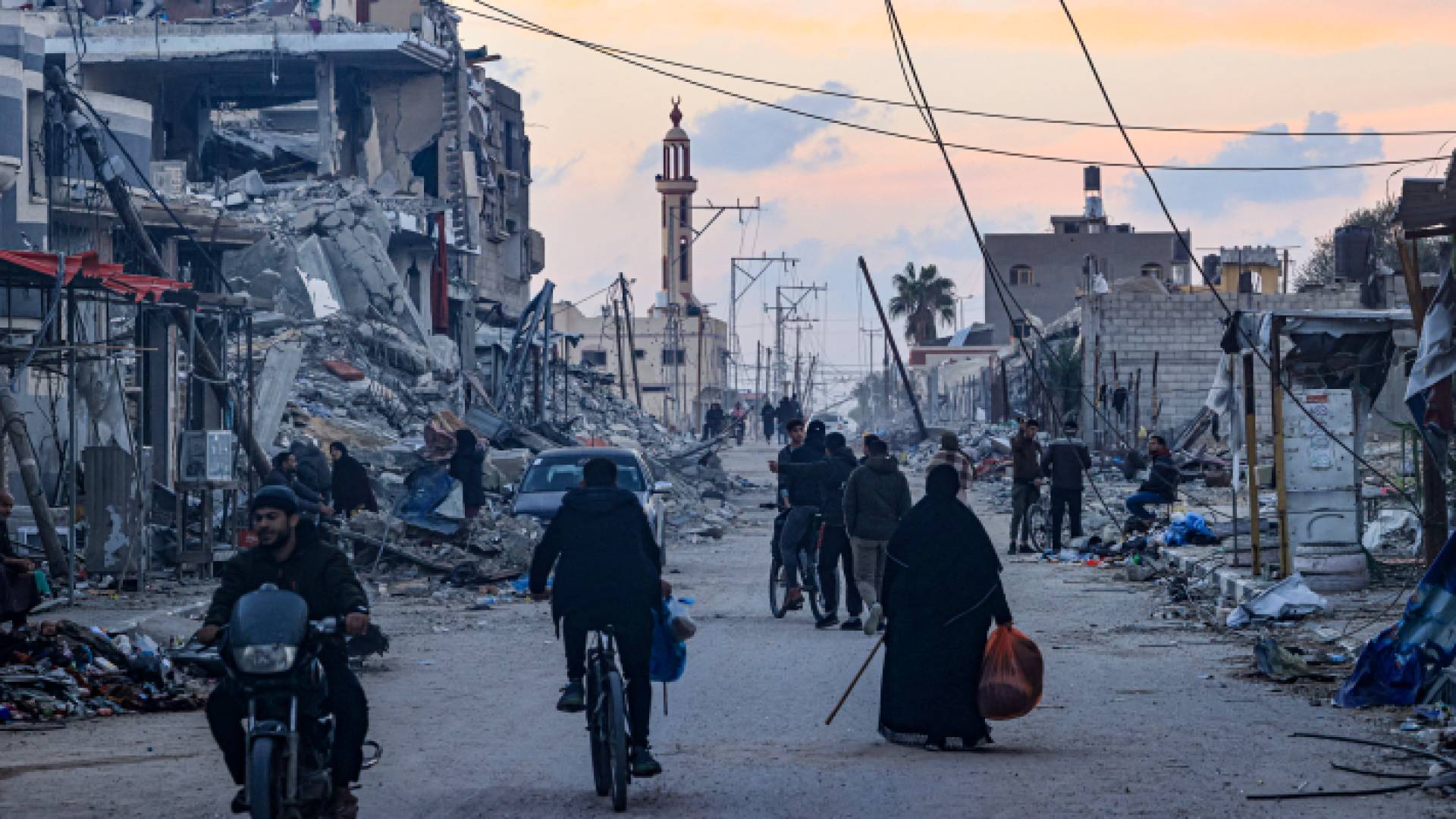 فلسطينيون وسط الدمار الذي خلفه الاحتلال في قطاع غزة