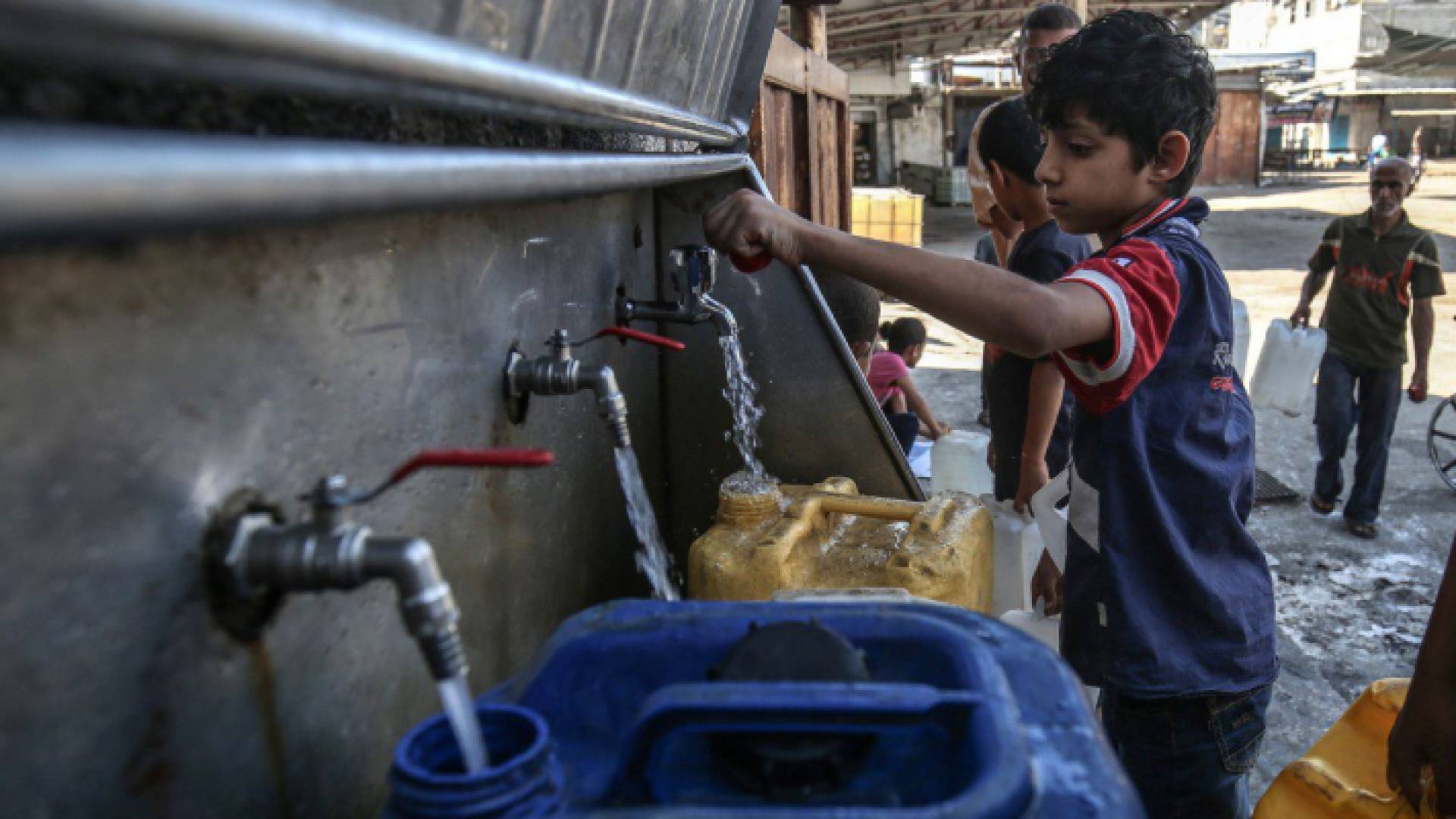 أطفال يعبون عبوات بالمياه في غزة