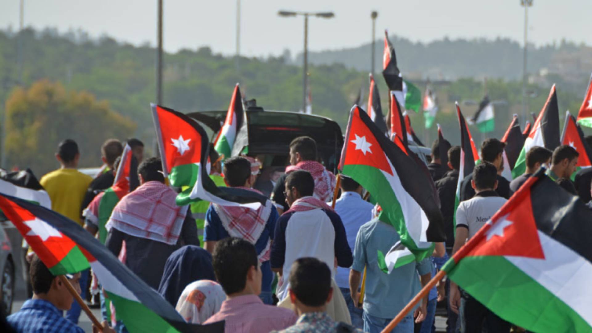 أردنيون يرفعون علم المملكة الأردنية الهاشمية