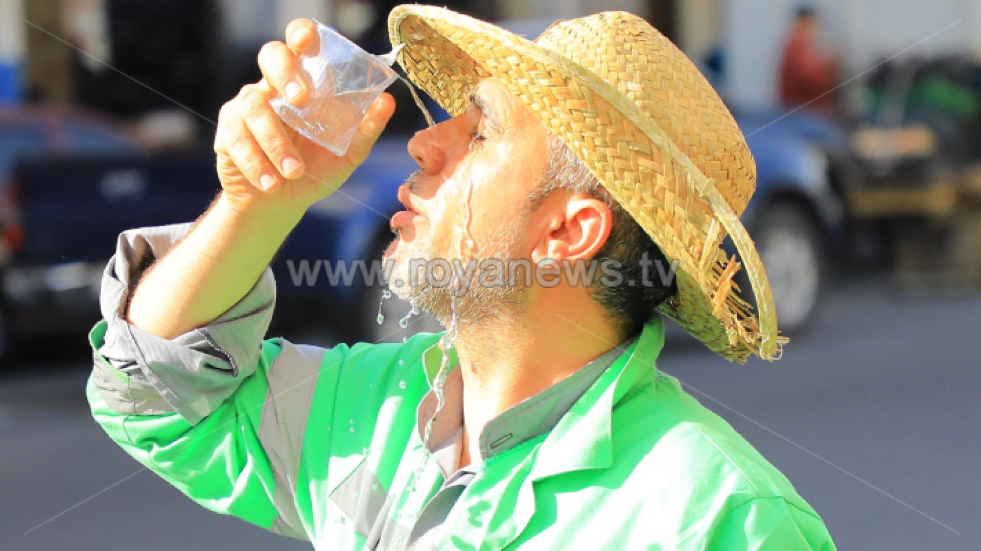 عامل وطن يسكب المياه على وجهه في ظل ارتفاع درجات الحرارة