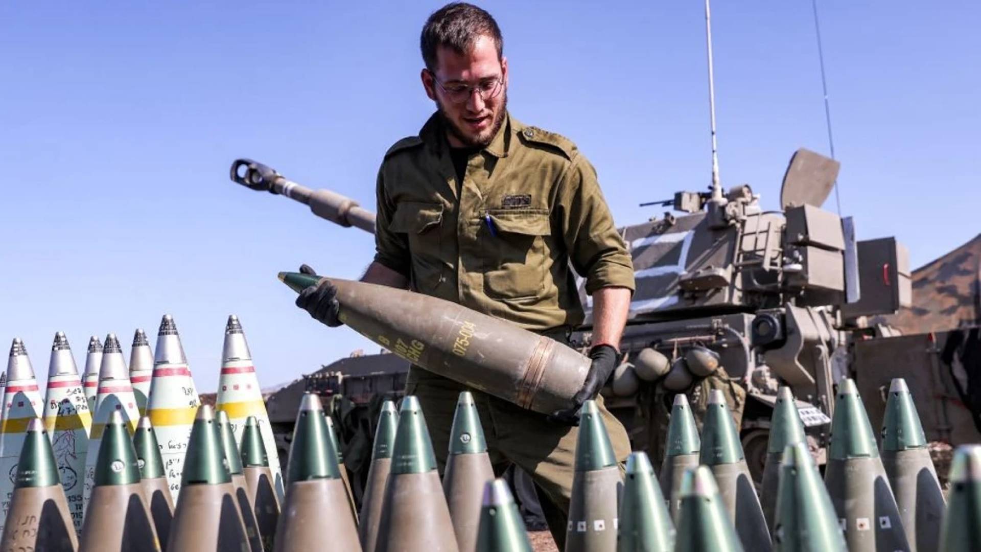 ذخائر وأسلحة يقوم جندي من جيش الاحتلال