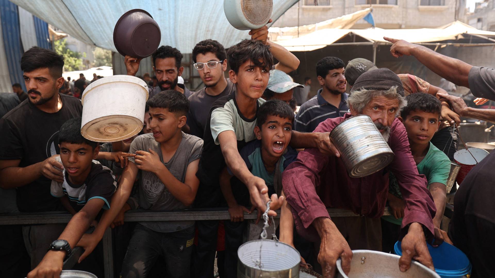 فلسطينيون ينتظرون حصولهم على القليل من الطعام في غزة