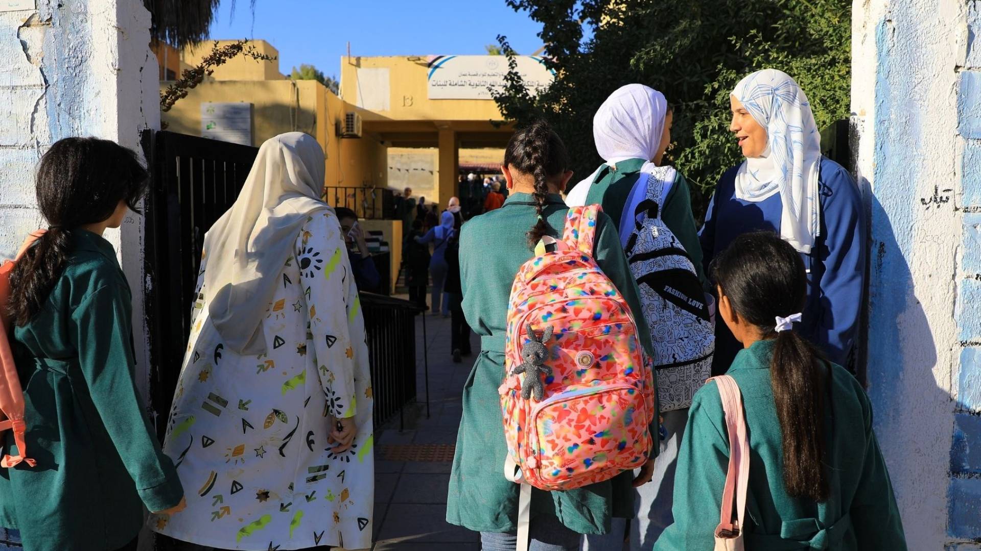 طالبة مدارس أمام مدرستهم